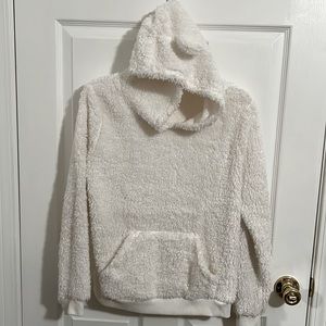Fuzzy white sweatshirt with pockets.